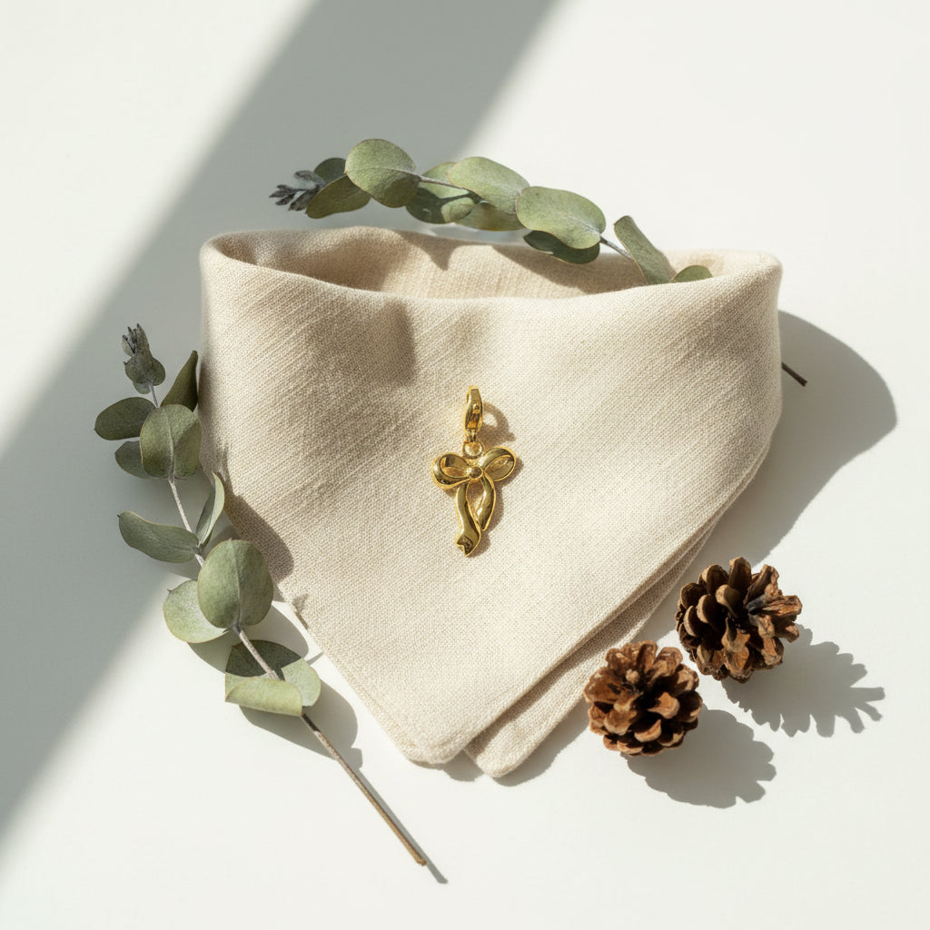 Gold bow-shaped pendant on a white background