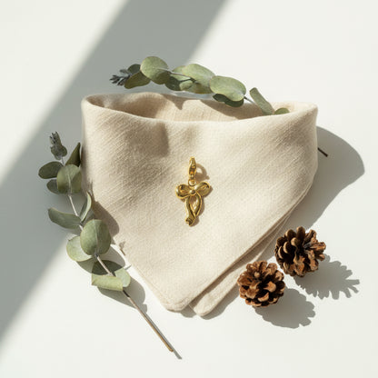 Gold bow-shaped pendant on a white background